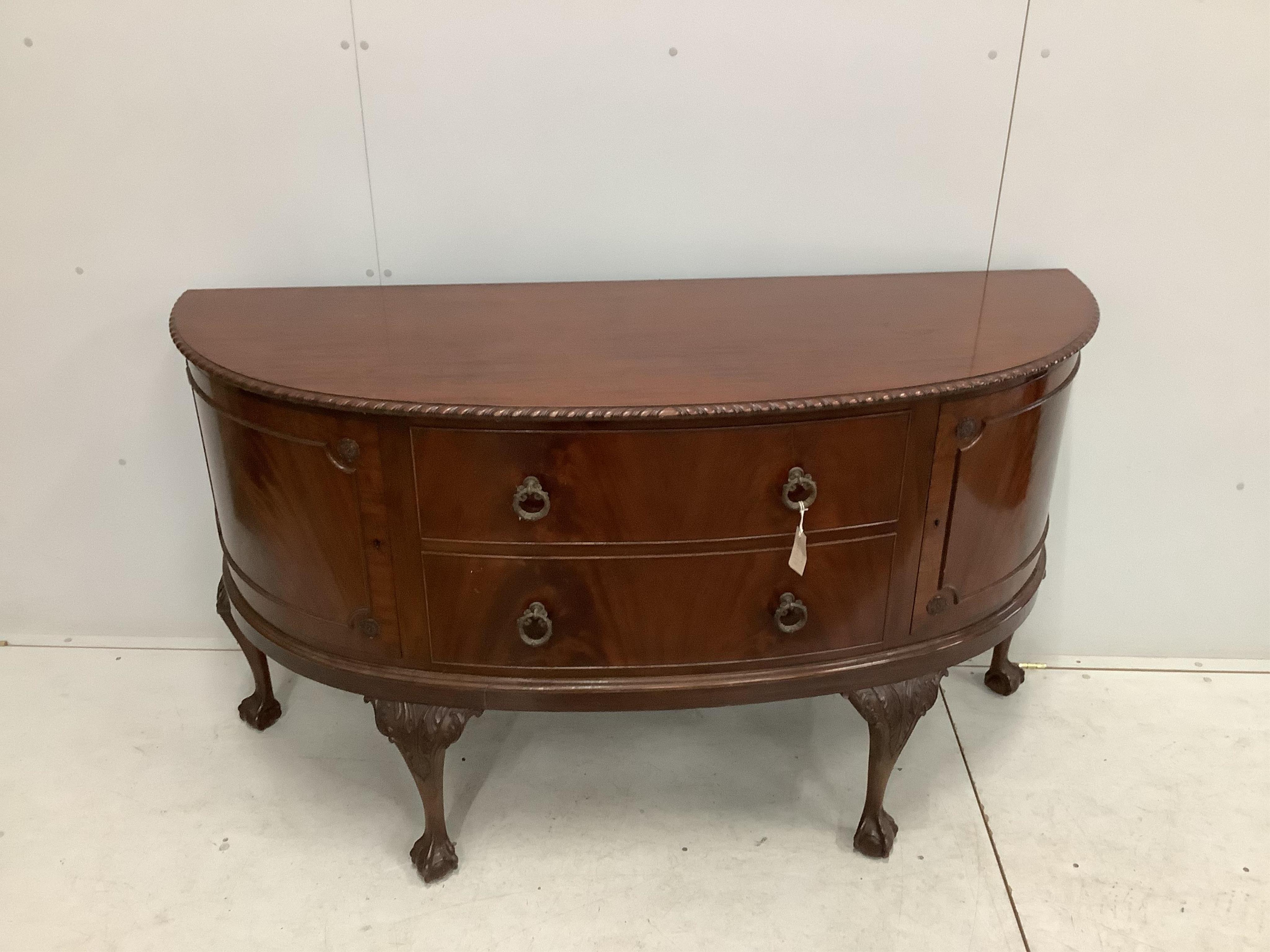 A Chippendale Revival mahogany dining suite comprising extending dining table, 210cm extended, two spare leaves, depth 106cm, height 75cm, bowfront sideboard and serving table, together with six dining chairs (two with a